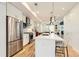 Modern kitchen with a large island, stainless steel appliances, and hardwood floors at 3880 W 13Th Ave, Denver, CO 80204