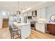 Modern kitchen featuring a large island with seating, stainless steel appliances, and white cabinetry at 3880 W 13Th Ave, Denver, CO 80204