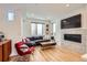 Cozy living room featuring a comfortable sectional sofa, modern fireplace, and hardwood floors at 3880 W 13Th Ave, Denver, CO 80204