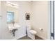 Modern powder room with a unique sink, stylish mirror, and clean design at 3880 W 13Th Ave, Denver, CO 80204