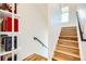A naturally lit staircase with hardwood treads and a modern black handrail at 3880 W 13Th Ave, Denver, CO 80204