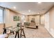 Finished basement with neutral carpet and walls, glass desk and white doors at 3353 Wabash St, Denver, CO 80238