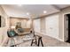 Finished basement with neutral carpet and walls, glass desk and white doors at 3353 Wabash St, Denver, CO 80238