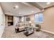 Spacious finished basement with sitting area, bar, and glass desk at 3353 Wabash St, Denver, CO 80238