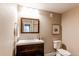 Bathroom with dark wood vanity, white countertop, a mirror and toilet at 3353 Wabash St, Denver, CO 80238
