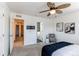 Bright bedroom with a ceiling fan, modern decor, and access to a bathroom and hallway at 3353 Wabash St, Denver, CO 80238