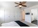 Bright bedroom featuring two closets, ceiling fan, and access to a bathroom at 3353 Wabash St, Denver, CO 80238