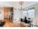 Bright dining area featuring wood floors, a decorative chandelier, and ample natural light at 3353 Wabash St, Denver, CO 80238