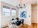 Elegant dining room with a modern chandelier, sleek table, and sunlit windows at 3353 Wabash St, Denver, CO 80238