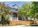 Charming two-story home with a red door, front porch, and a picket fence at 3353 Wabash St, Denver, CO 80238