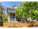 Charming blue two-story home with a red door and white trim at 3353 Wabash St, Denver, CO 80238