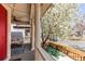 Inviting front porch with a comfortable seating area and a beautiful blooming tree at 3353 Wabash St, Denver, CO 80238