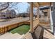 Inviting front porch with wood floors, posts, and a charming view of the neighborhood street at 3353 Wabash St, Denver, CO 80238