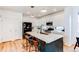 Modern kitchen featuring white cabinets, a large island, and stainless steel appliances at 3353 Wabash St, Denver, CO 80238