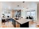 Open-concept kitchen with a large island that flows into the living and dining area at 3353 Wabash St, Denver, CO 80238