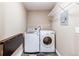 Laundry room with LG washer and dryer on tile flooring and wire shelving at 3353 Wabash St, Denver, CO 80238