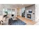 Cozy living room featuring a fireplace, comfortable seating, and natural light at 3353 Wabash St, Denver, CO 80238