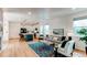 Open concept living room and kitchen featuring modern appliances and stylish decor at 3353 Wabash St, Denver, CO 80238
