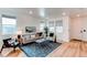Bright living room featuring large windows, comfortable seating, and stylish decor at 3353 Wabash St, Denver, CO 80238