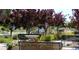 Picturesque pocket park featuring decorative benches, lush greenery, and a charming water feature at 3353 Wabash St, Denver, CO 80238