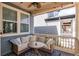 Relaxing covered porch with cushioned seating, fan and string lights at 3353 Wabash St, Denver, CO 80238