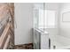 Modern bathroom shower featuring white subway tile, glass enclosure, and wood accent wall at 3353 Wabash St, Denver, CO 80238