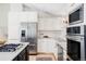 Modern kitchen featuring stainless steel appliances, white cabinetry, and hardwood flooring at 360 S Hoyt St, Lakewood, CO 80226