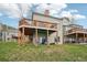 Rear exterior with multi-tiered decks and manicured lawn at 758 Chimney Creek Dr # C, Golden, CO 80401