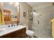 Charming bathroom with a wood vanity, framed mirror, and glass enclosed shower at 758 Chimney Creek Dr # C, Golden, CO 80401