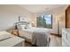 Bright bedroom with hardwood floors, large window with mountain views, and a desk at 758 Chimney Creek Dr # C, Golden, CO 80401