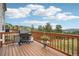 Wooden deck with a grill and small table, perfect for enjoying the scenic mountain views at 758 Chimney Creek Dr # C, Golden, CO 80401