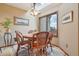 Cozy dining room with a round table, four chairs, and bright natural light from the window at 758 Chimney Creek Dr # C, Golden, CO 80401