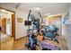 Spacious home gym featuring hardwood floors, an elliptical, and exercise bike at 758 Chimney Creek Dr # C, Golden, CO 80401