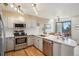Bright eat-in kitchen with stainless appliances and stone countertops at 758 Chimney Creek Dr # C, Golden, CO 80401