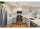 Bright kitchen featuring stainless steel appliances and stone countertops at 758 Chimney Creek Dr # C, Golden, CO 80401