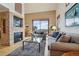 Cozy living room with a stone fireplace, stylish sofas, and a view from a window at 758 Chimney Creek Dr # C, Golden, CO 80401