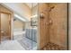 Bright main bathroom featuring a glass shower, soaking tub, and neutral tile at 758 Chimney Creek Dr # C, Golden, CO 80401