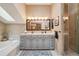 Bright bathroom featuring a large soaking tub, double vanity, and glass-enclosed shower at 758 Chimney Creek Dr # C, Golden, CO 80401