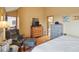 Relaxing main bedroom with reading chair, light wood floors, and warm natural light at 758 Chimney Creek Dr # C, Golden, CO 80401