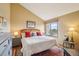 Comfortable main bedroom with a white comforter, bedside tables, and a large window at 758 Chimney Creek Dr # C, Golden, CO 80401