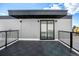 A modern balcony with sleek black metal railings and geometric floor tiles, offering a private outdoor space at 1416 Pierce St, Lakewood, CO 80214