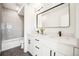 Modern bathroom with dual sink vanity, sleek fixtures, and tiled shower/tub at 1416 Pierce St, Lakewood, CO 80214
