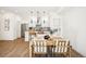 Modern dining area with wood table, stylish chairs, and an adjacent kitchen with stainless steel appliances at 1416 Pierce St, Lakewood, CO 80214