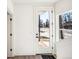 Bright entryway features full light door, vinyl floors, crisp white walls, and black hardware at 1416 Pierce St, Lakewood, CO 80214