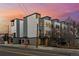 Contemporary townhomes with modern siding and black trim accents; professionally landscaped and complemented by a colorful sunset at 1416 Pierce St, Lakewood, CO 80214