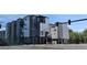 Modern townhomes feature a striking gray and white exterior with street access and top floor balconies at 1416 Pierce St, Lakewood, CO 80214