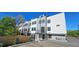 Modern townhomes feature white and gray facade with small wrought iron balconies and dedicated parking at 1416 Pierce St, Lakewood, CO 80214