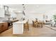 Modern kitchen features an island with bar seating, pendant lighting, and stainless steel appliances at 1416 Pierce St, Lakewood, CO 80214