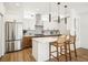 Bright, modern kitchen featuring an island, stainless steel appliances, and stylish pendant lighting at 1416 Pierce St, Lakewood, CO 80214