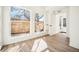 Bright living room features vinyl floors, oversized windows, base-white walls, and recessed lighting at 1416 Pierce St, Lakewood, CO 80214